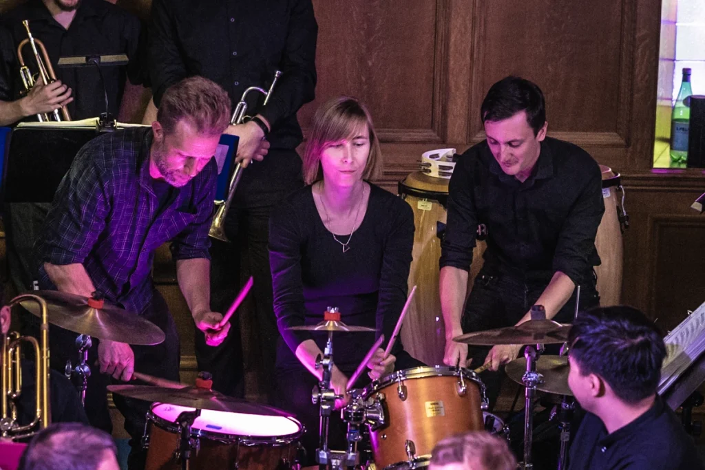 Three jazz drummers all playing the same kit at the same time