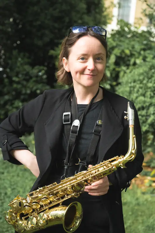 Portrait of a saxophone player smiling naturally after relaxing in front of the camera